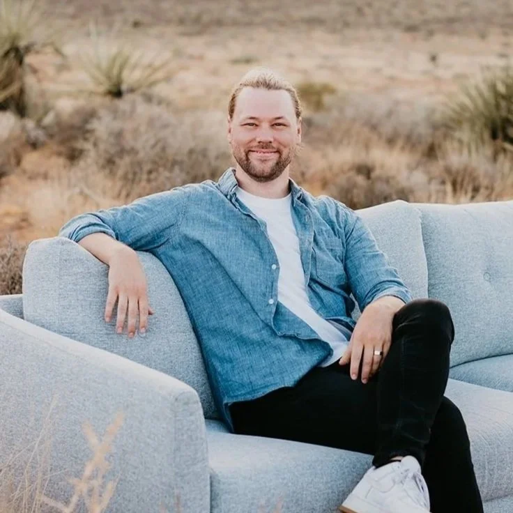 Ryan Greenwood seated on a couch